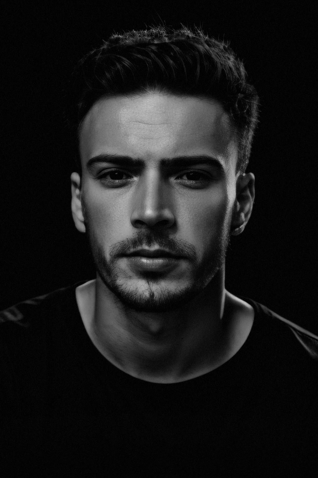 KYNEO, photographed in black and white against a black background.